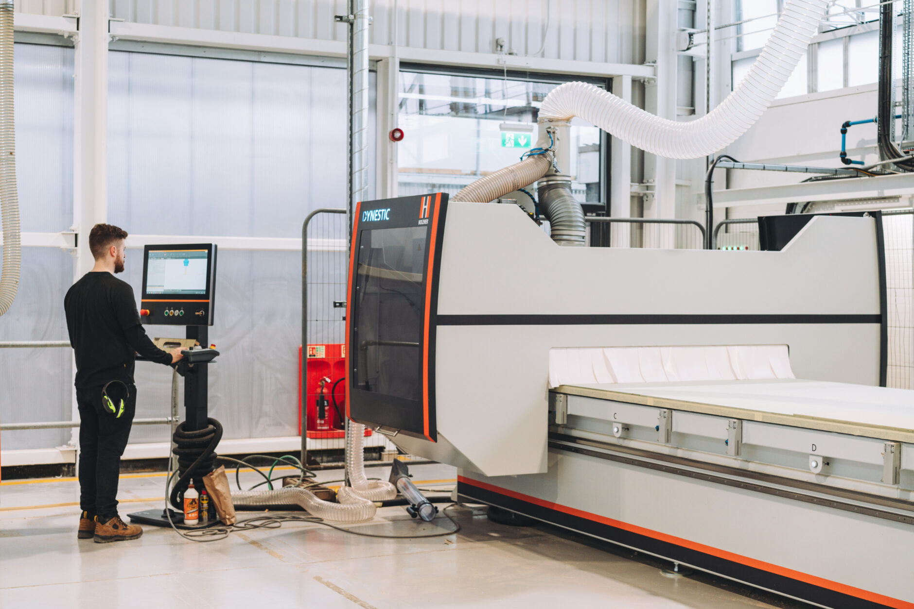 A maker member uses the new Dynestic 7505 flatbed CNC router in the CNC suite at Bloqs' new open access factory. Photo: Claudia Agati. 