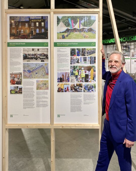 Architect John Christophers, responsible for the Net Zero House in the exhibition, with the Retrofit Balsall Heath and Retrofit Reimagined Festival displays.